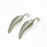 A pair of metallic silver pepper-shaped earrings with hook backs, displayed on a clean white background.