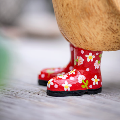 Red floral-patterned rain boots on a wooden surface