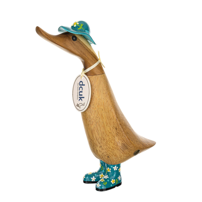 Wooden duck figurine wearing a hat and boots with a visible brand tag on a white background