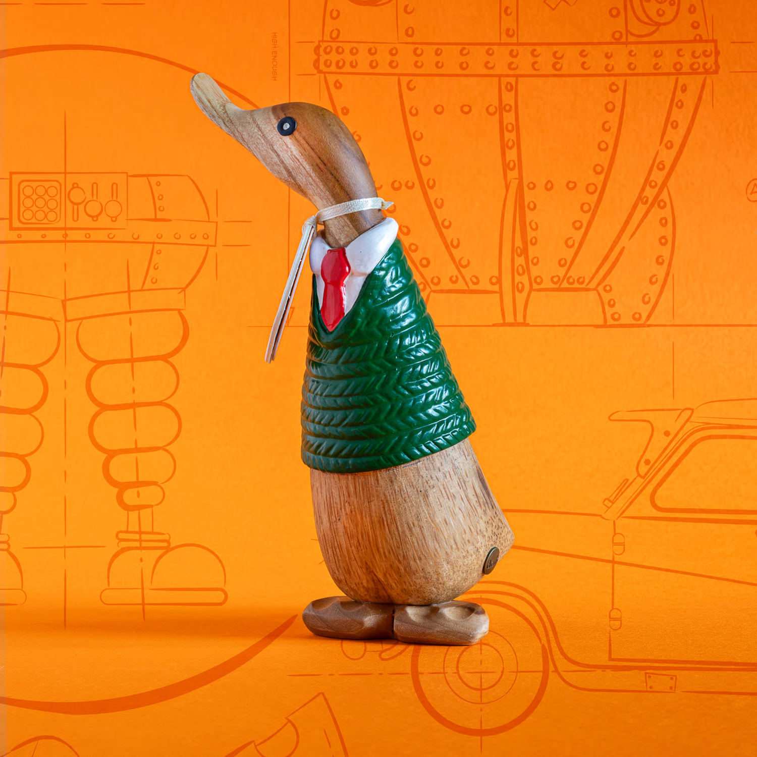 Wooden duck figure wearing a green jacket and red tie on an orange background with technical drawings.