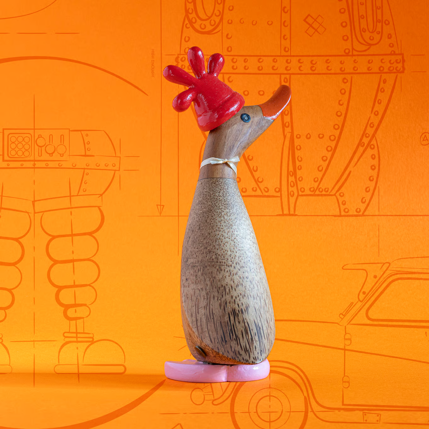 Wooden duck with red head on a pink platform against an orange background with line drawings