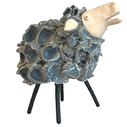 Decorative sculpture of a sheep with a textured wooly body on a white background