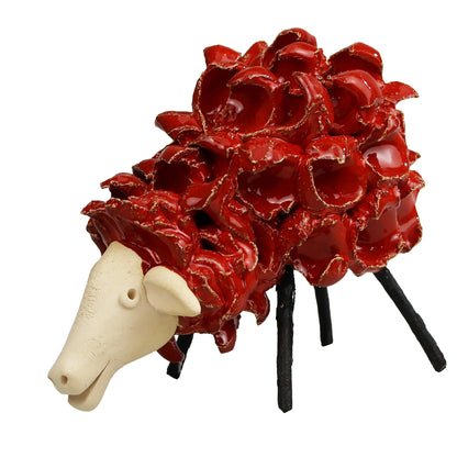 Decorative animal figurine with a red textured body and white face on a white background