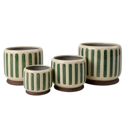 Set of four ceramic planters with green vertical stripes on a white background
