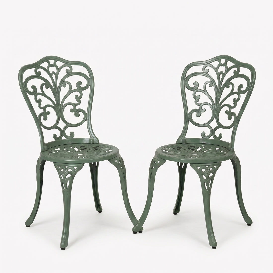 Two green metal chairs with intricate designs on a white background