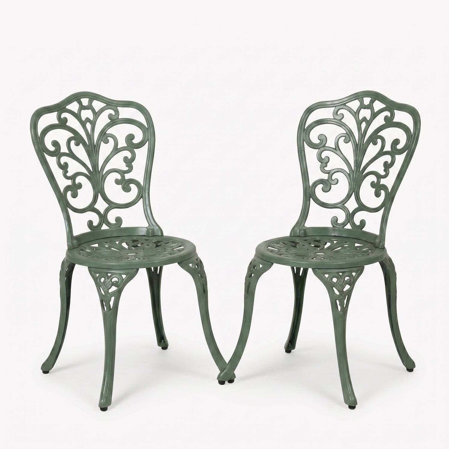 Two green metal chairs with intricate designs on a white background