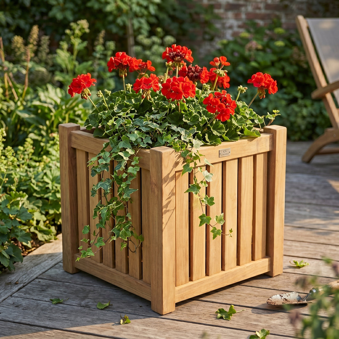 Wooden planter with red flowers on a wooden deck