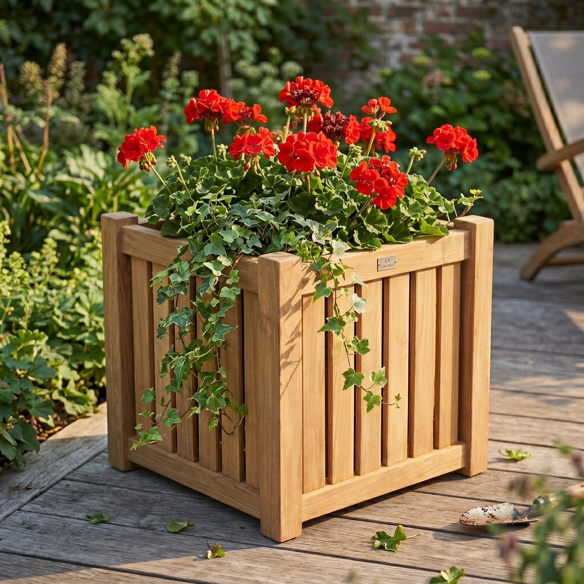 Wooden planter with red flowers on a wooden deck