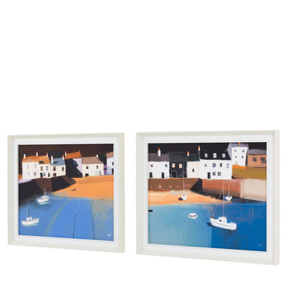 Two framed paintings of a coastal scene with houses and boats.