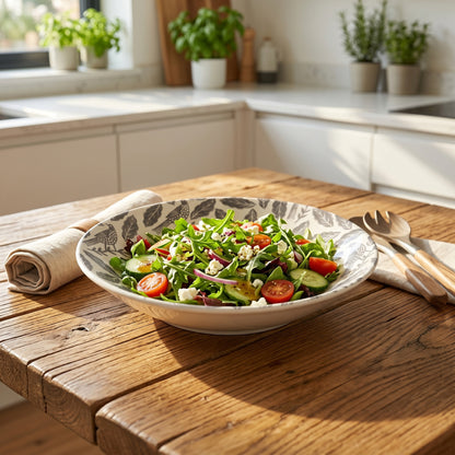 Bowl of salad on a wooden table in a kitchen