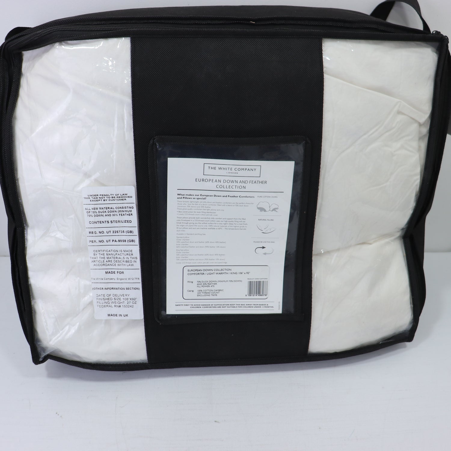a black and white bag with a white sheet