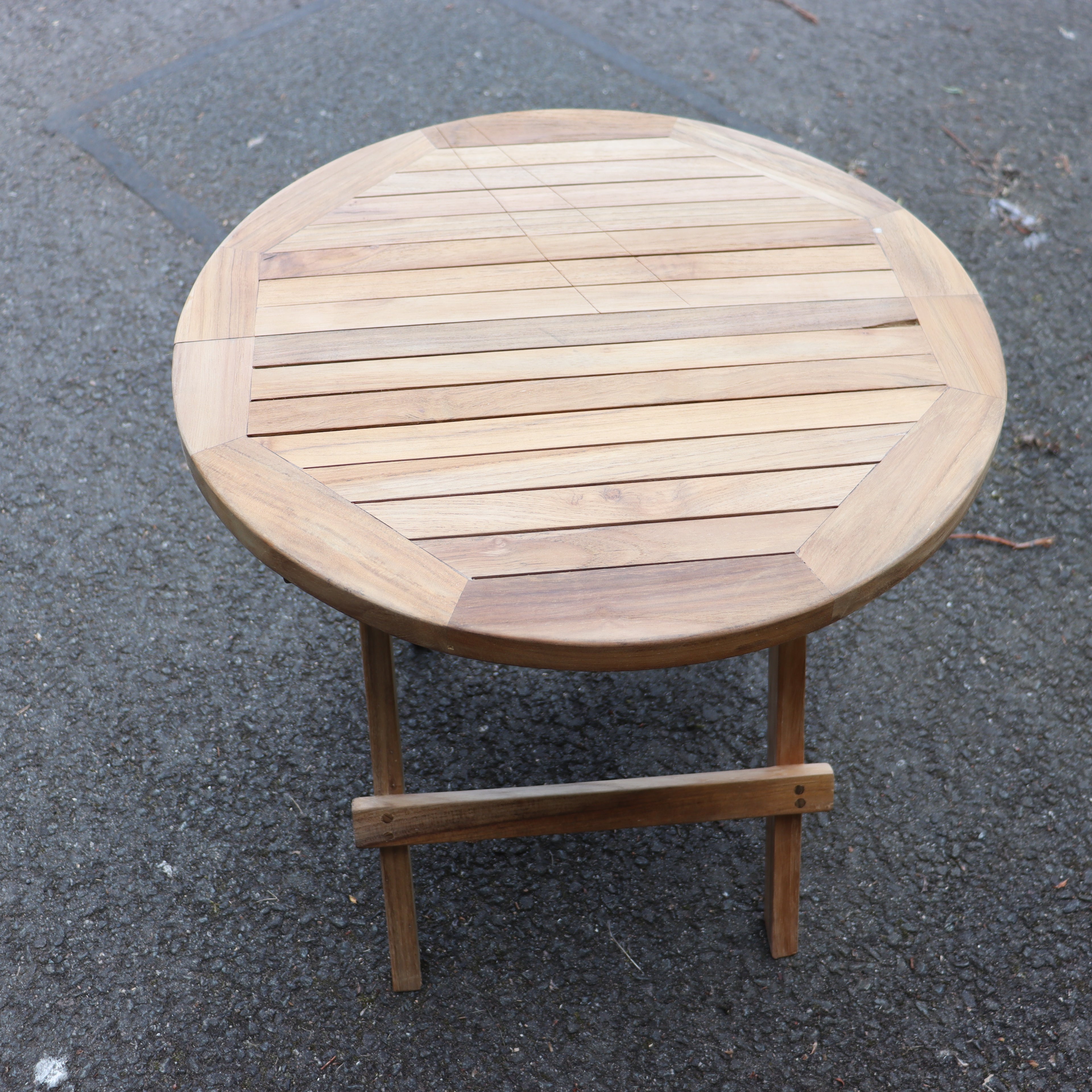 a wooden table on a pavement