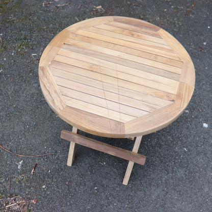 a wooden table on a pavement