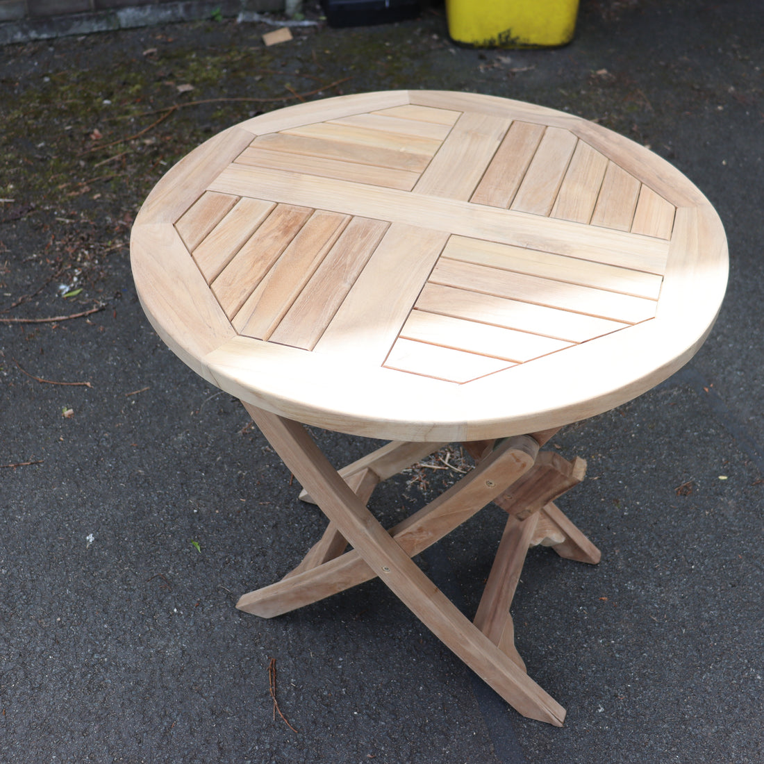 a wooden table on a pavement