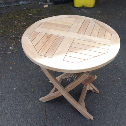 a wooden table on a pavement