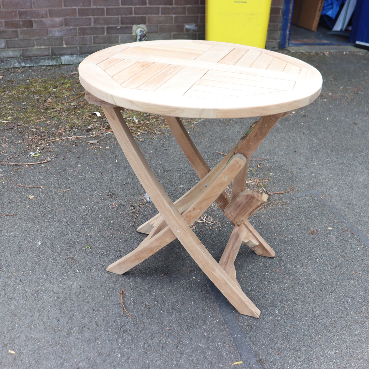 a wooden table on a pavement