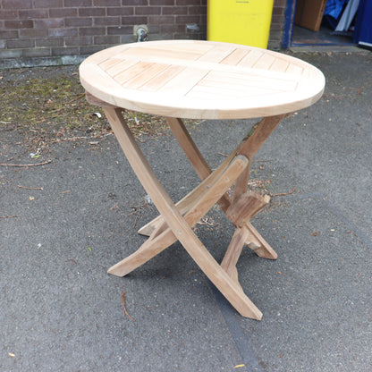 a wooden table on a pavement