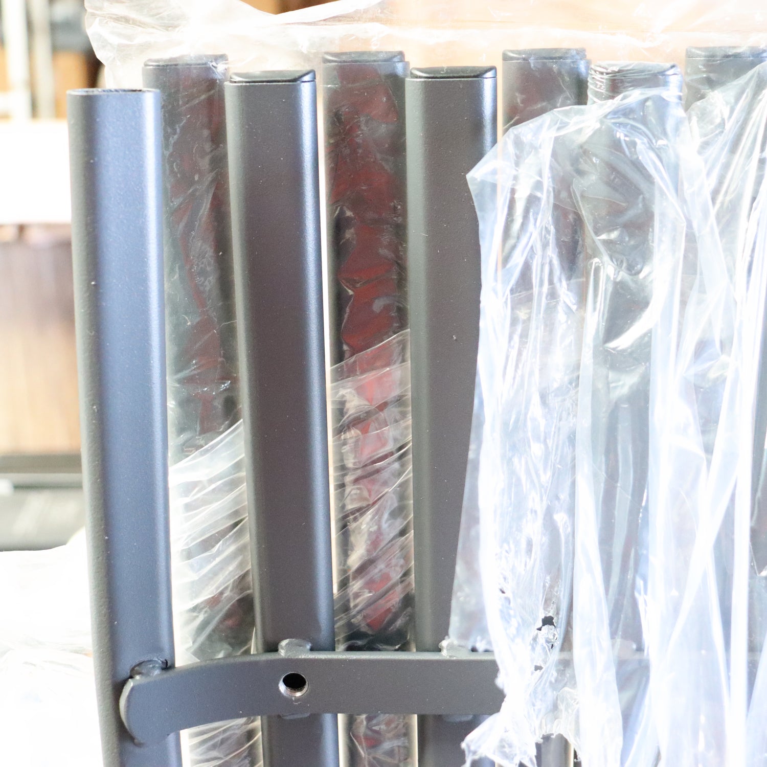 a metal bar with plastic wrap around it
