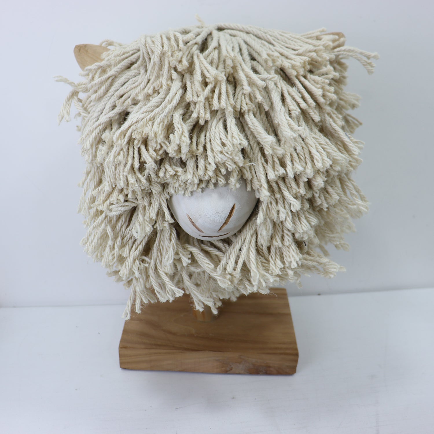 a white mop on a wood stand