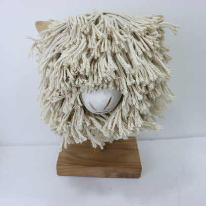 a white mop on a wood stand