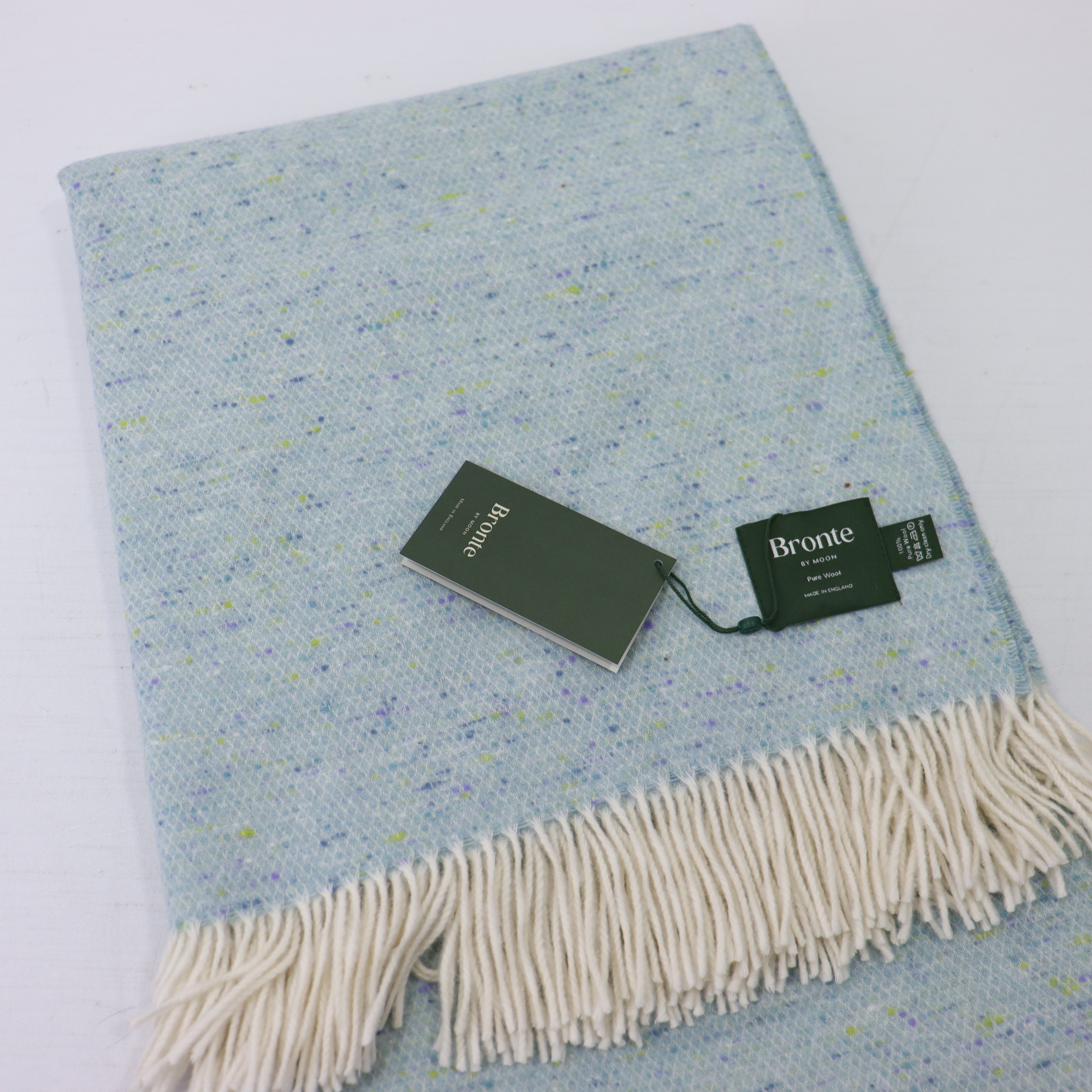 a blue and white blanket with a tag on it