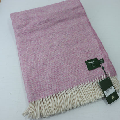 a pink and white blanket with a tag