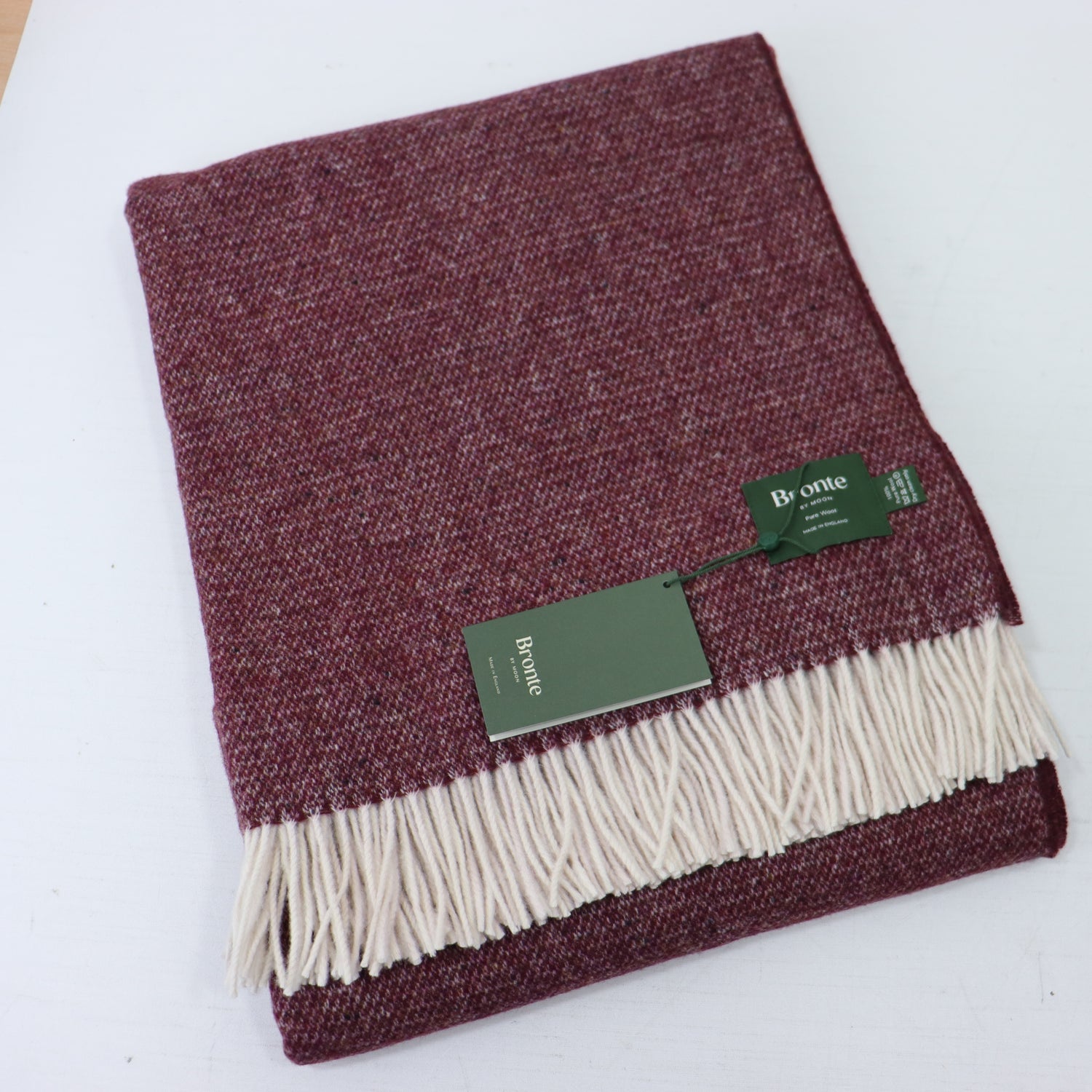 a red and white blanket with a green tag