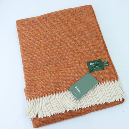 a brown and white blanket with a tag
