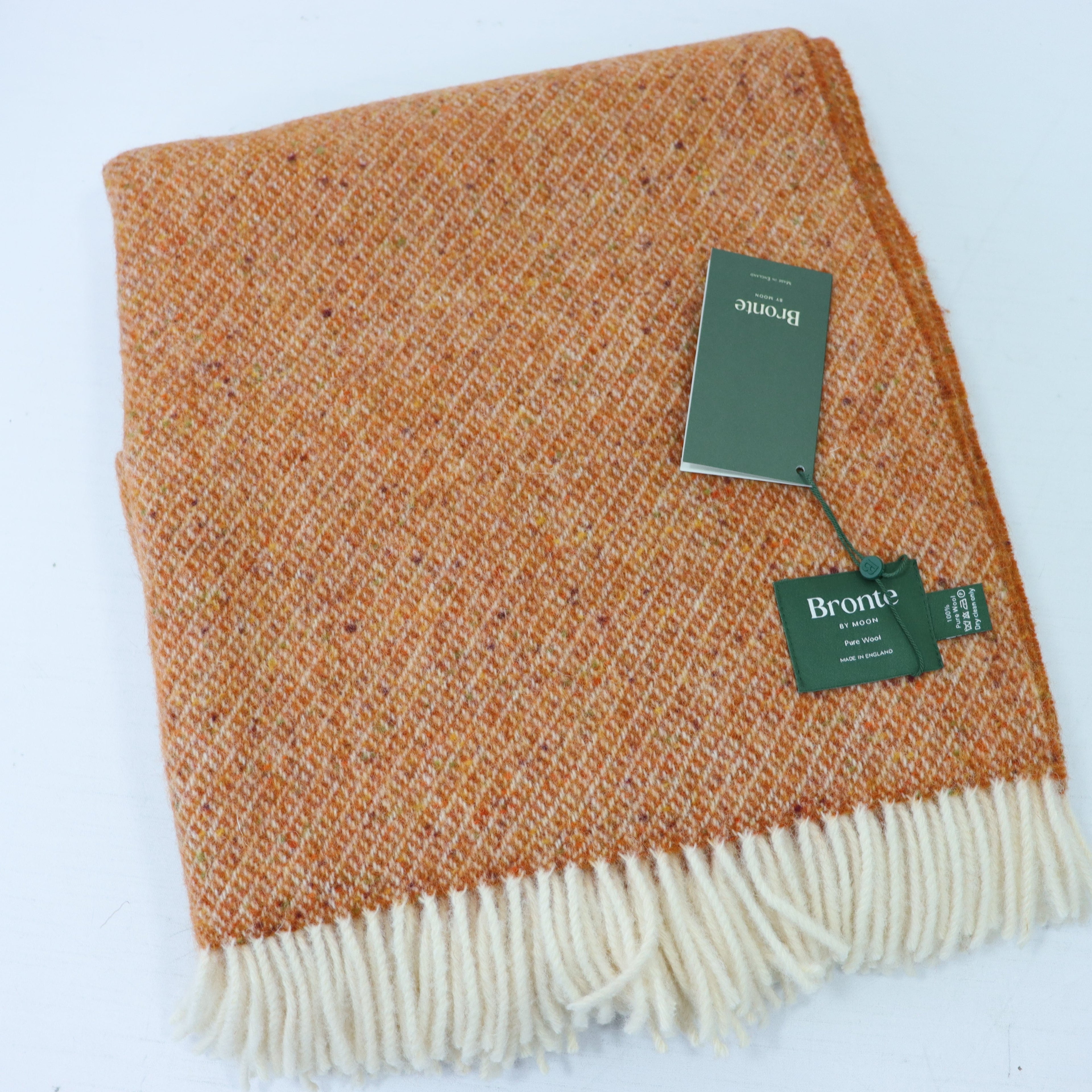 a brown and white blanket with a tag