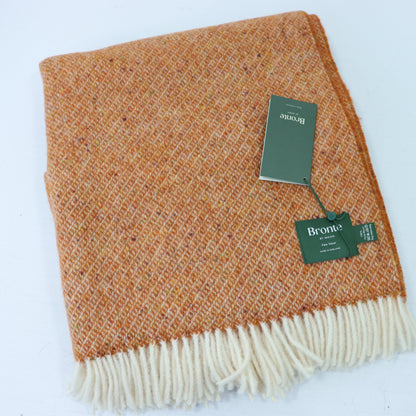 a brown and white blanket with a tag