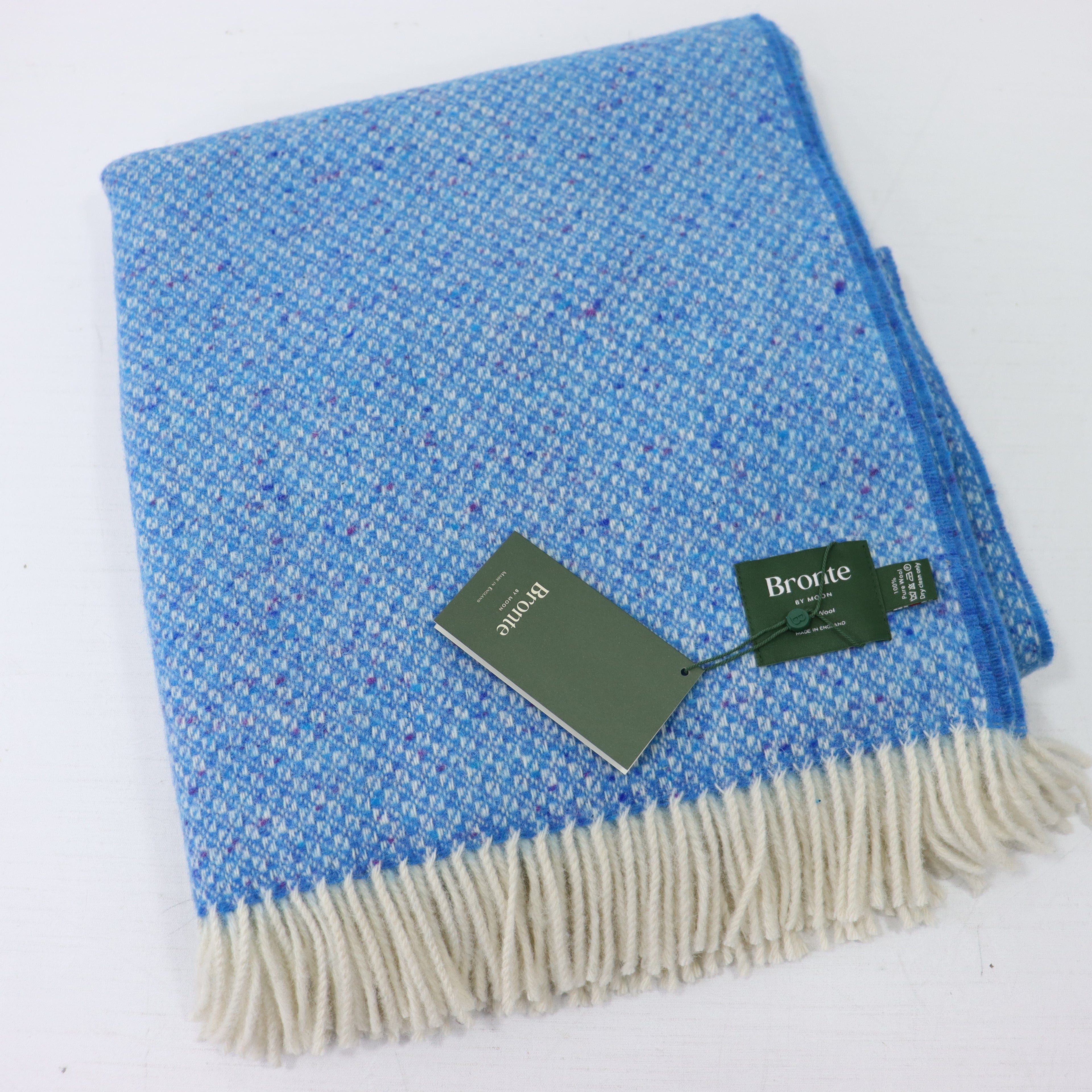 a blue and white blanket with a tag