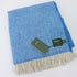 a blue and white blanket with a tag