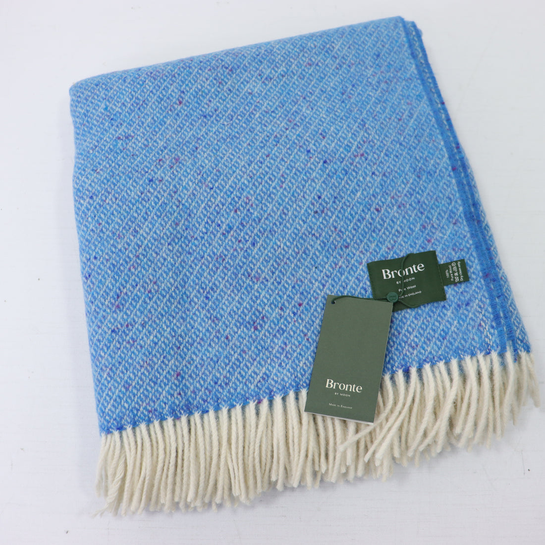 a blue and white blanket with a tag