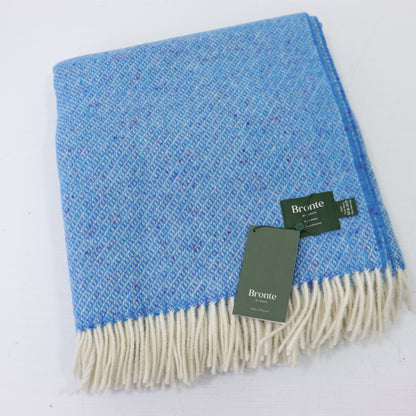 a blue and white blanket with a tag