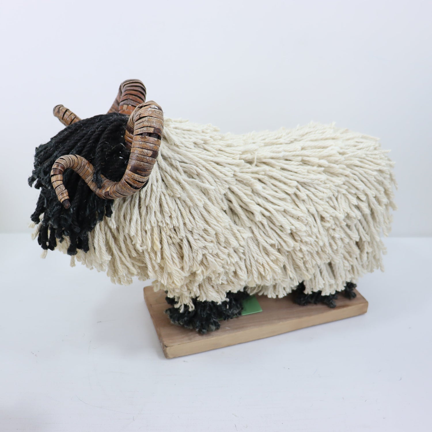 Aquarelle Home Rupert Sheep with horns side view. Black face with cream body