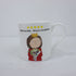 a white mug with a cartoon character on it
