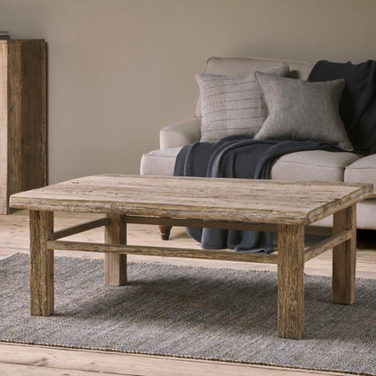 Living room with a wooden coffee table, beige sofa, and wooden sideboard.