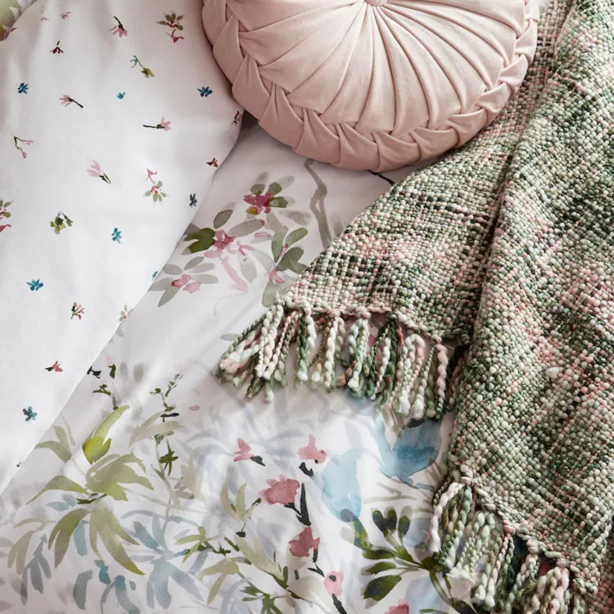 a pillow and blanket on a bed
