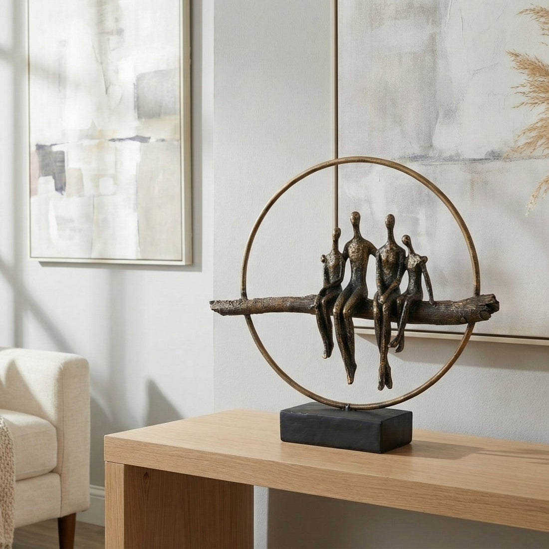 Decorative sculpture on a table in a living room with a couch and artwork.