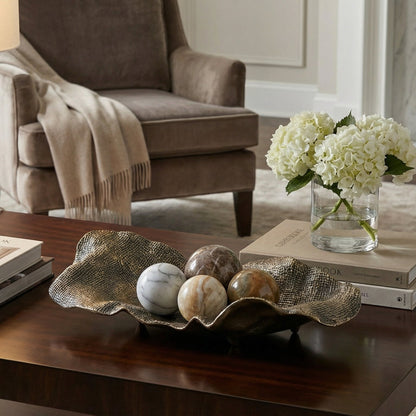 Living room with a coffee table, armchair, and decorative items.