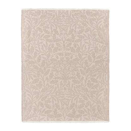 Beige area rug with subtle leaf pattern on a white background