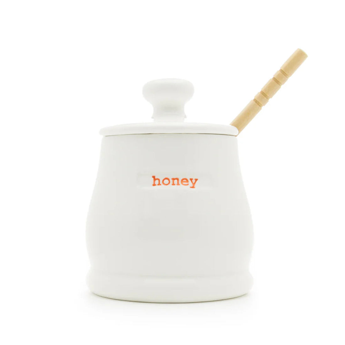 White ceramic honey jar with a wooden dipper on a white background
