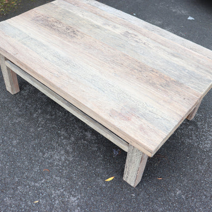 Wooden table on a dark asphalt surface