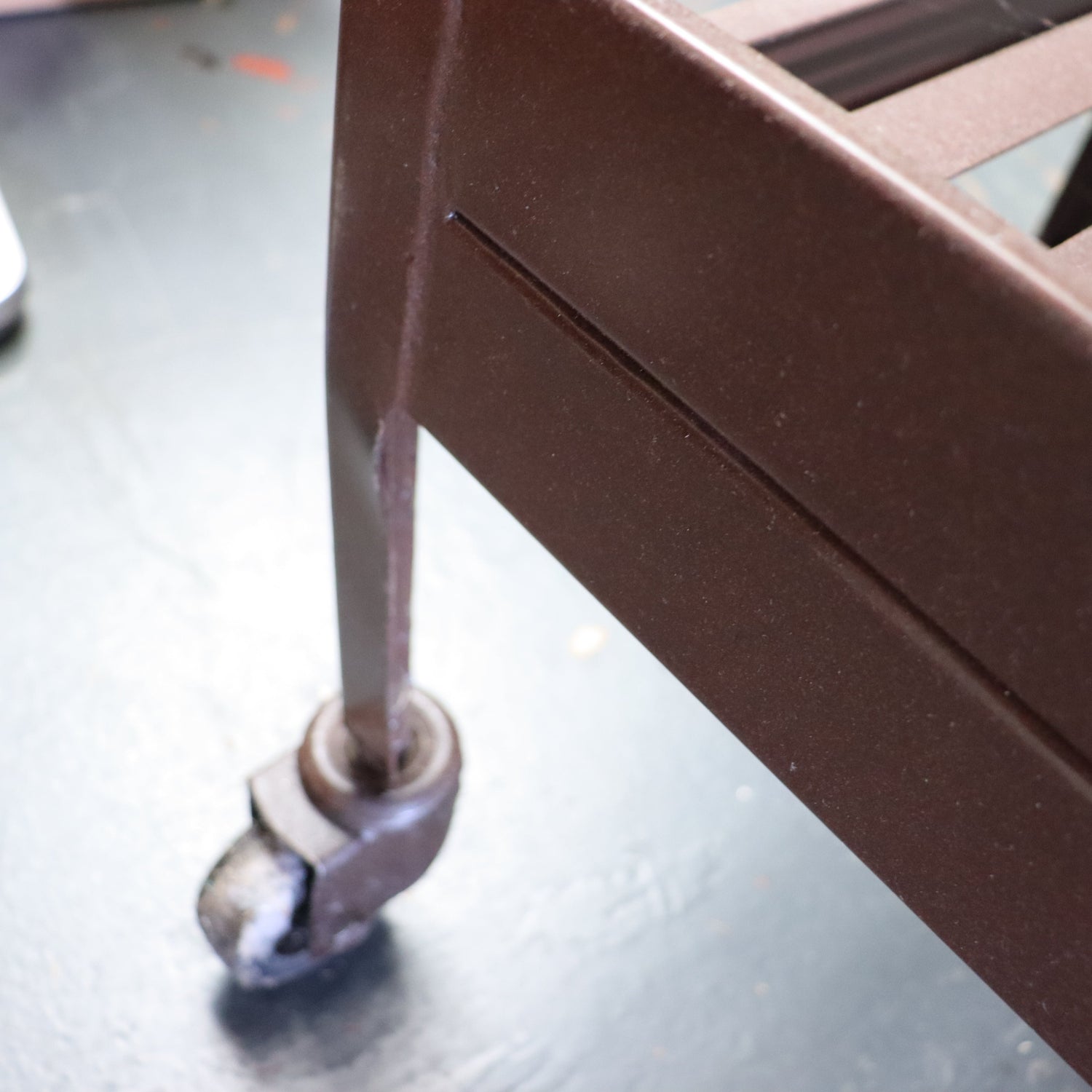 Close-up of a metal handle on a piece of furniture with a blurred background