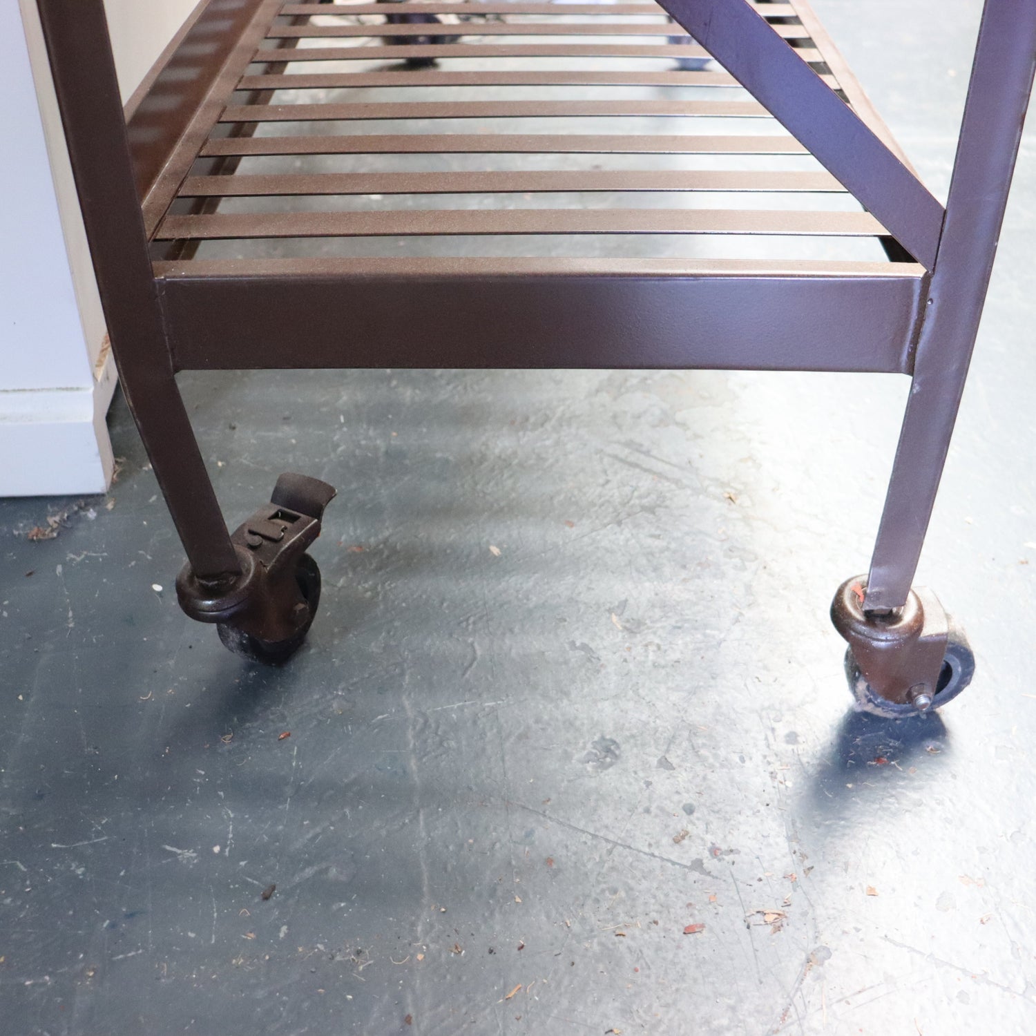 Metal rolling cart with wheels on a concrete floor