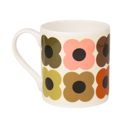 A white ceramic mug featuring a retro floral pattern of large, stylized flowers in olive green, pink, brown, yellow, and orange with dark centers, shown on a plain white background.
