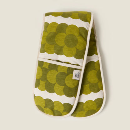 Pair of green patterned oven mitts on a beige background