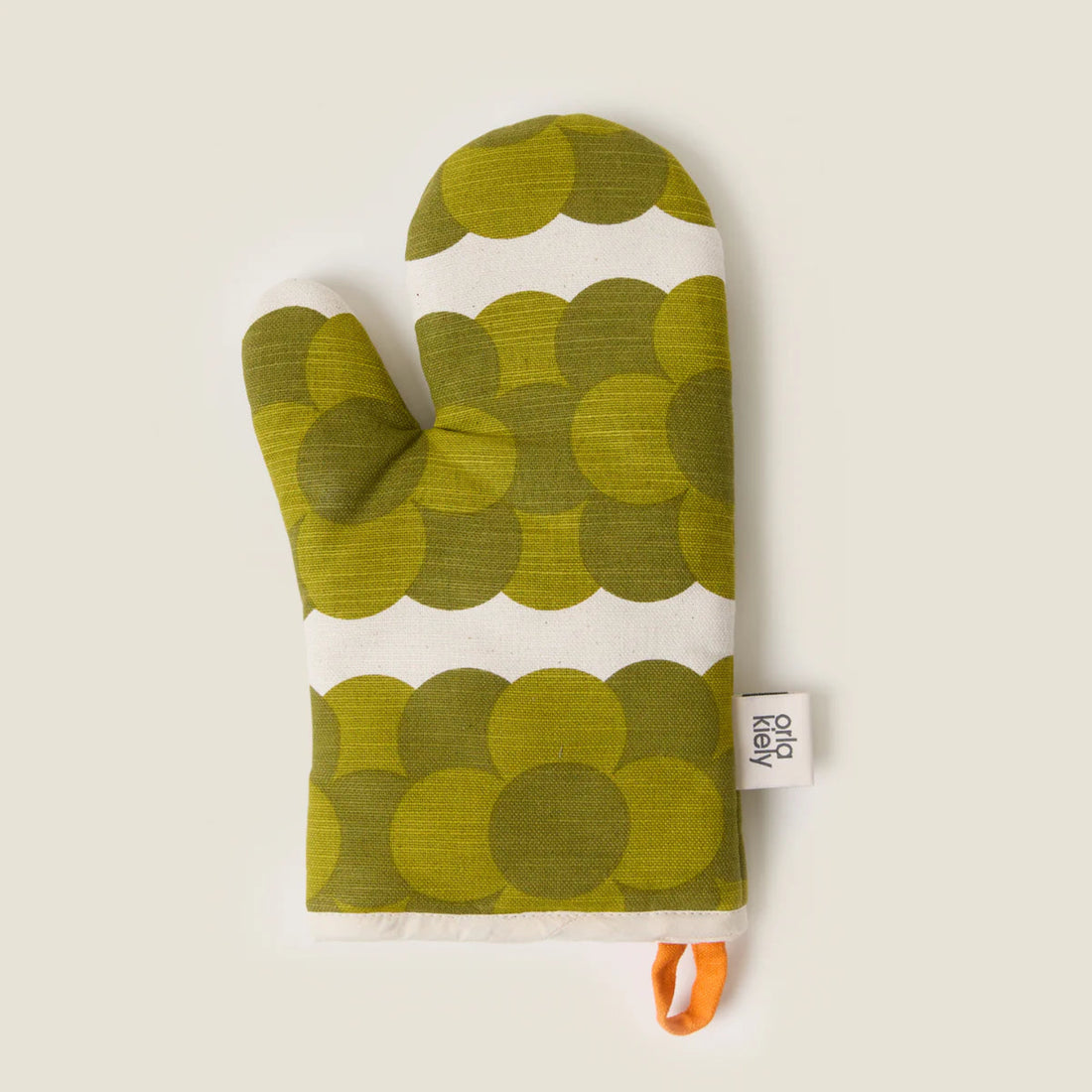 Green patterned oven mitt with a white label on a beige background