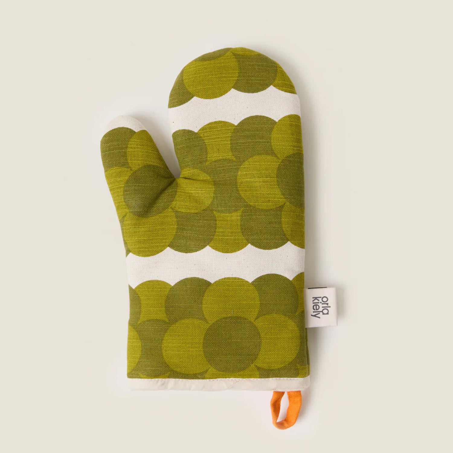 Green patterned oven mitt with a white label on a beige background