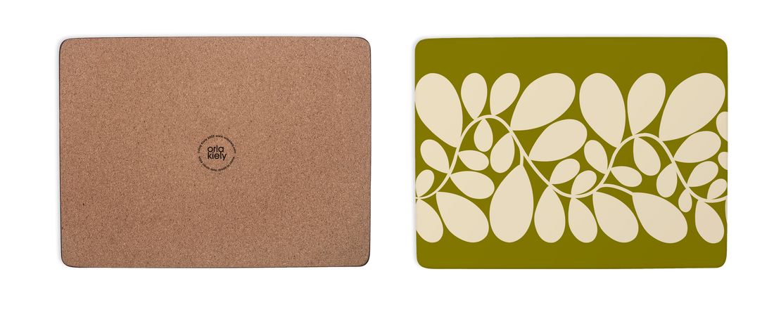 Brown cork mat and green placemat with leaf pattern on a white background